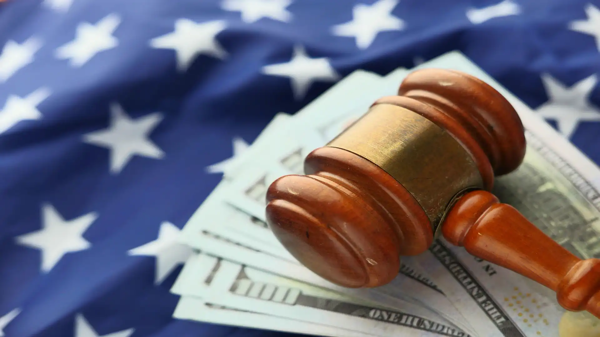 AI safety regulations — real photo of a judge's gavel on dollar bills over an American flag