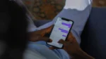 Claude AI free online — real photo of hands texting in a chat app on a smartphone