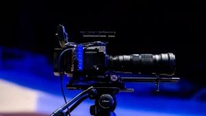 Runway AI video generator — real photo of a professional cinema camera on a tripod under blue lighting