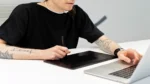 AI image generator free no sign up — real photo of a person drawing on a graphics tablet with a stylus