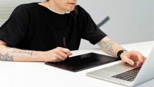 AI image generator free no sign up — real photo of a person drawing on a graphics tablet with a stylus
