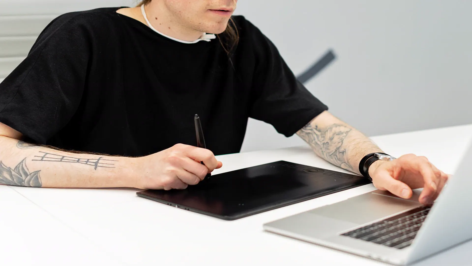 AI image generator free no sign up — real photo of a person drawing on a graphics tablet with a stylus