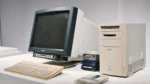 who created artificial intelligence — vintage CRT monitor, beige keyboard and tower PC from the early computing era on display