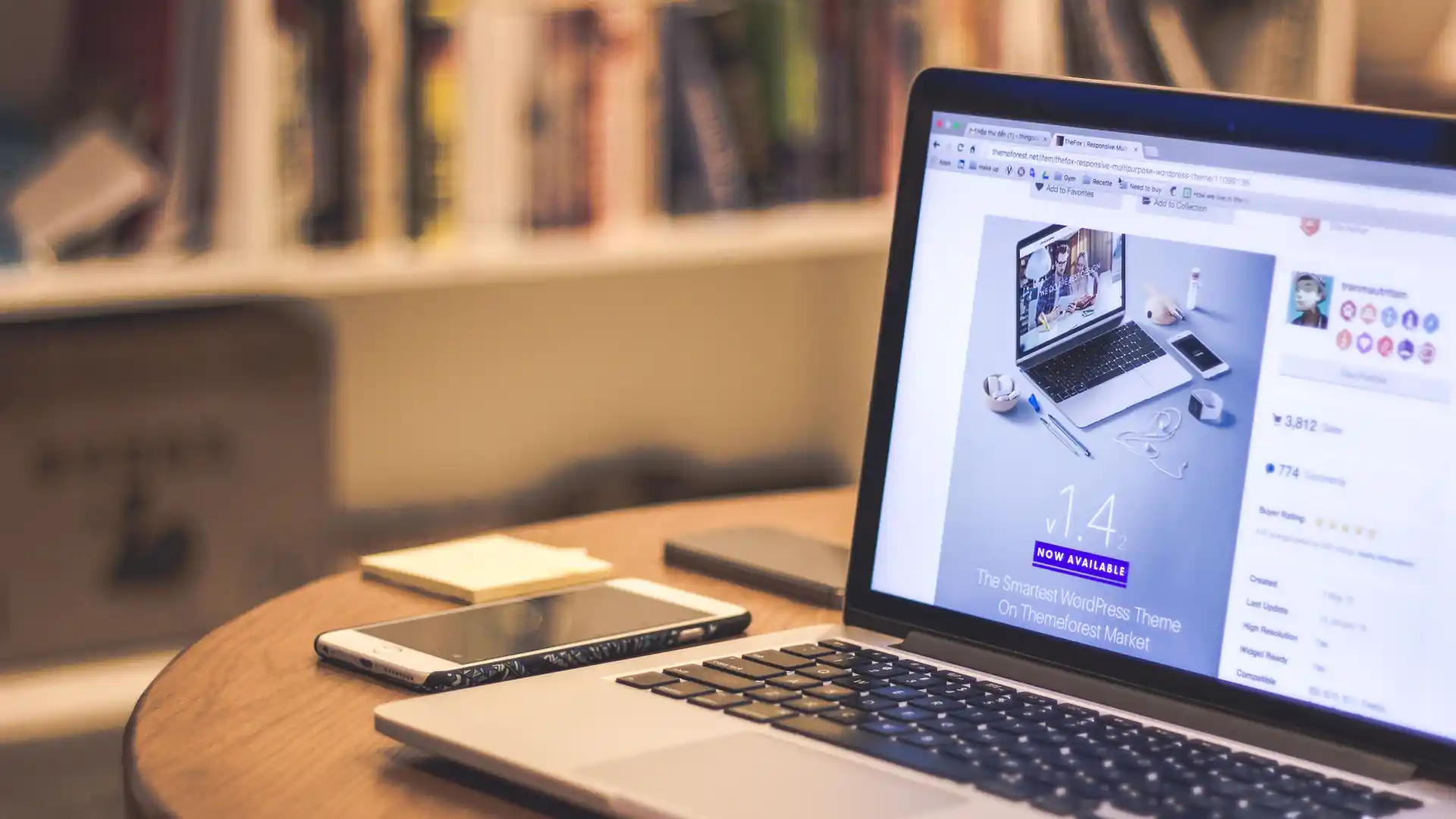 ai landing page builder — a laptop on a wooden desk displays a website design page beside a smartphone.