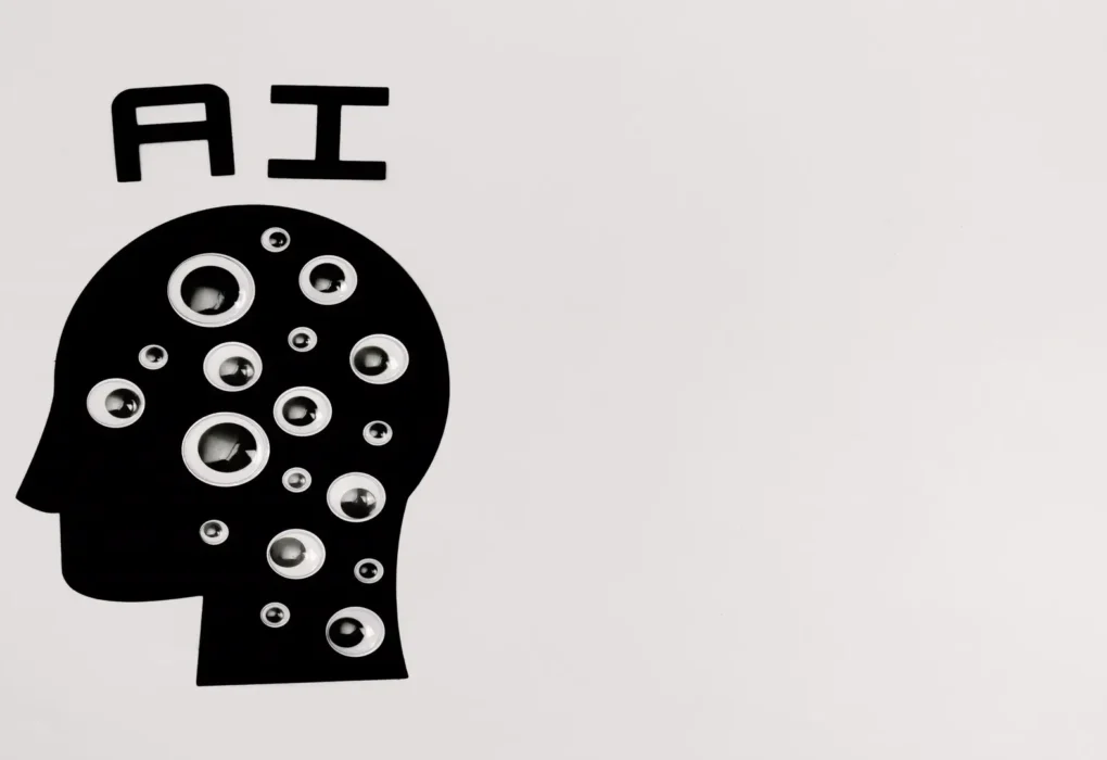 Mistral Large 4 model explained — real photo of a black-and-white paper-cut artwork showing a head silhouette filled with eyeballs under the word AI