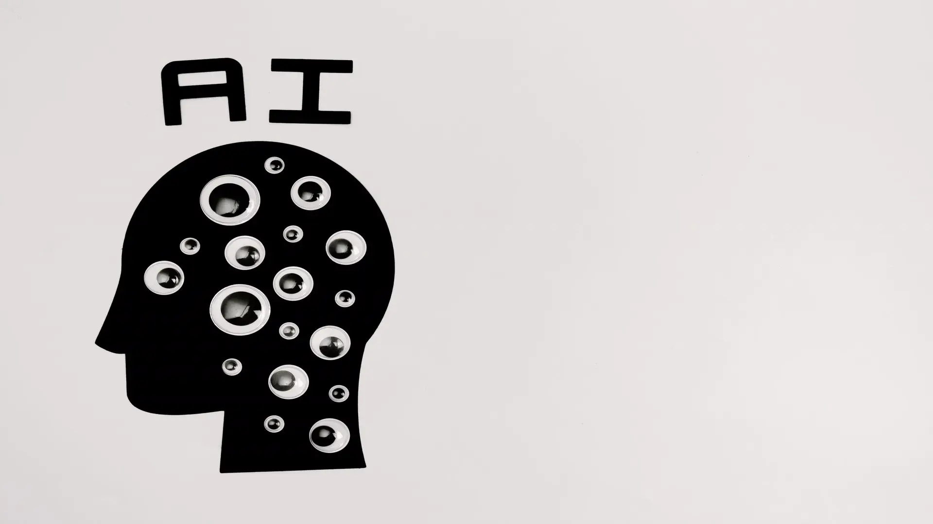 Mistral Large 4 model explained — real photo of a black-and-white paper-cut artwork showing a head silhouette filled with eyeballs under the word AI