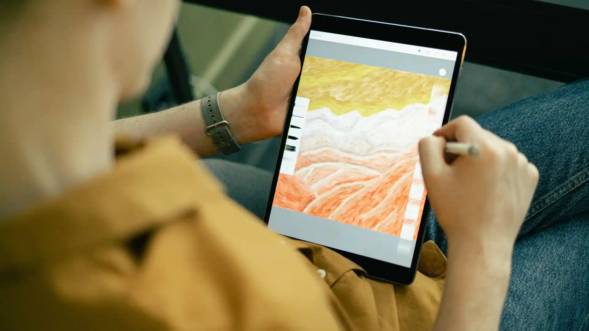 nano banana 2.1 release — Person using a stylus to create a colorful digital painting on a tablet, shown over the shoulder