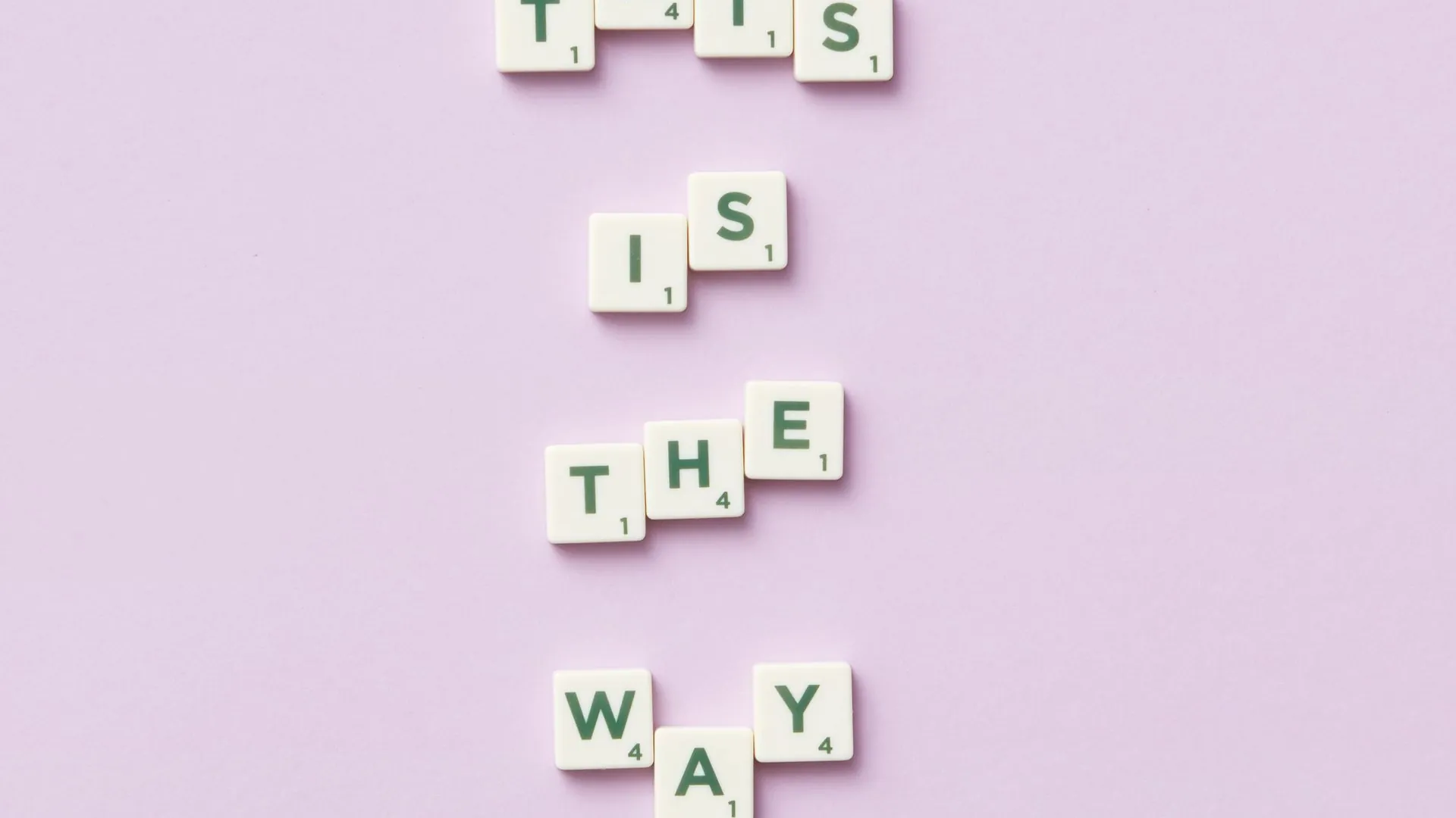 nyt connections purple category tips — Scrabble letter tiles spelling the phrase This is the way on a pastel purple background, seen from above.