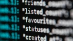 ai regex generator free — Extreme close-up of code on a dark screen showing text fields like friends_count, listed_count, favourites, statuses and created