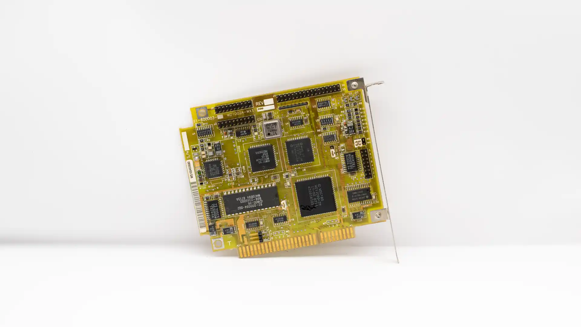 who created artificial intelligence — vintage green circuit board with black microchips on a white background