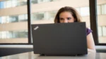 Build AI automation workflow without coding — real photo of a woman working on a laptop in a bright office