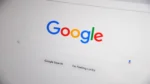 How AI search is changing Google rankings — real photo of the Google search homepage on a screen