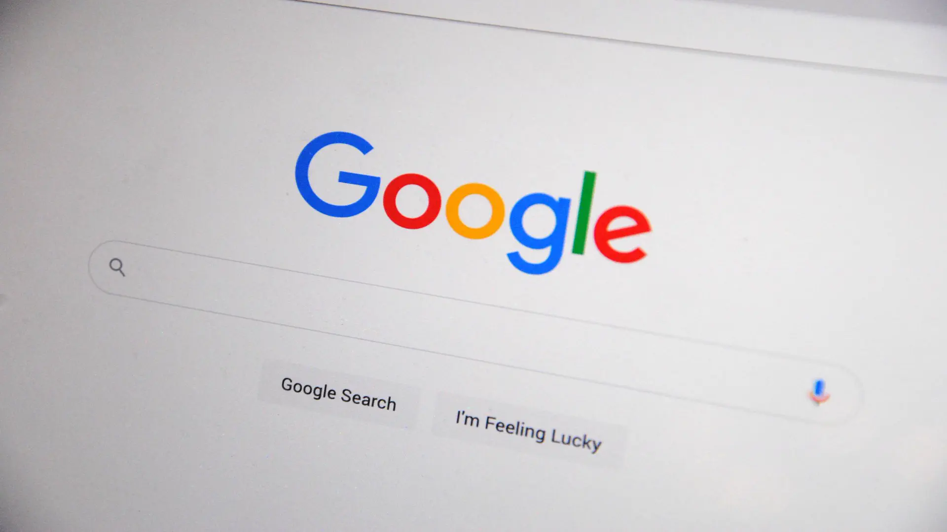 How AI search is changing Google rankings — real photo of the Google search homepage on a screen