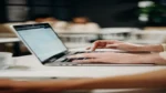 AI email marketing for small business — real photo of hands typing on a laptop in an office