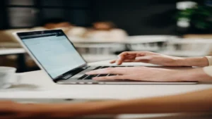 AI email marketing for small business — real photo of hands typing on a laptop in an office