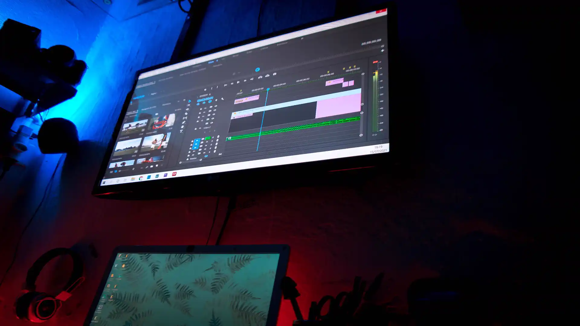 AI video editing tools for YouTubers — real photo of a monitor showing a video editing timeline in a dark studio