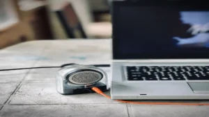 AI text to speech tools — real photo of a small speaker connected to a laptop