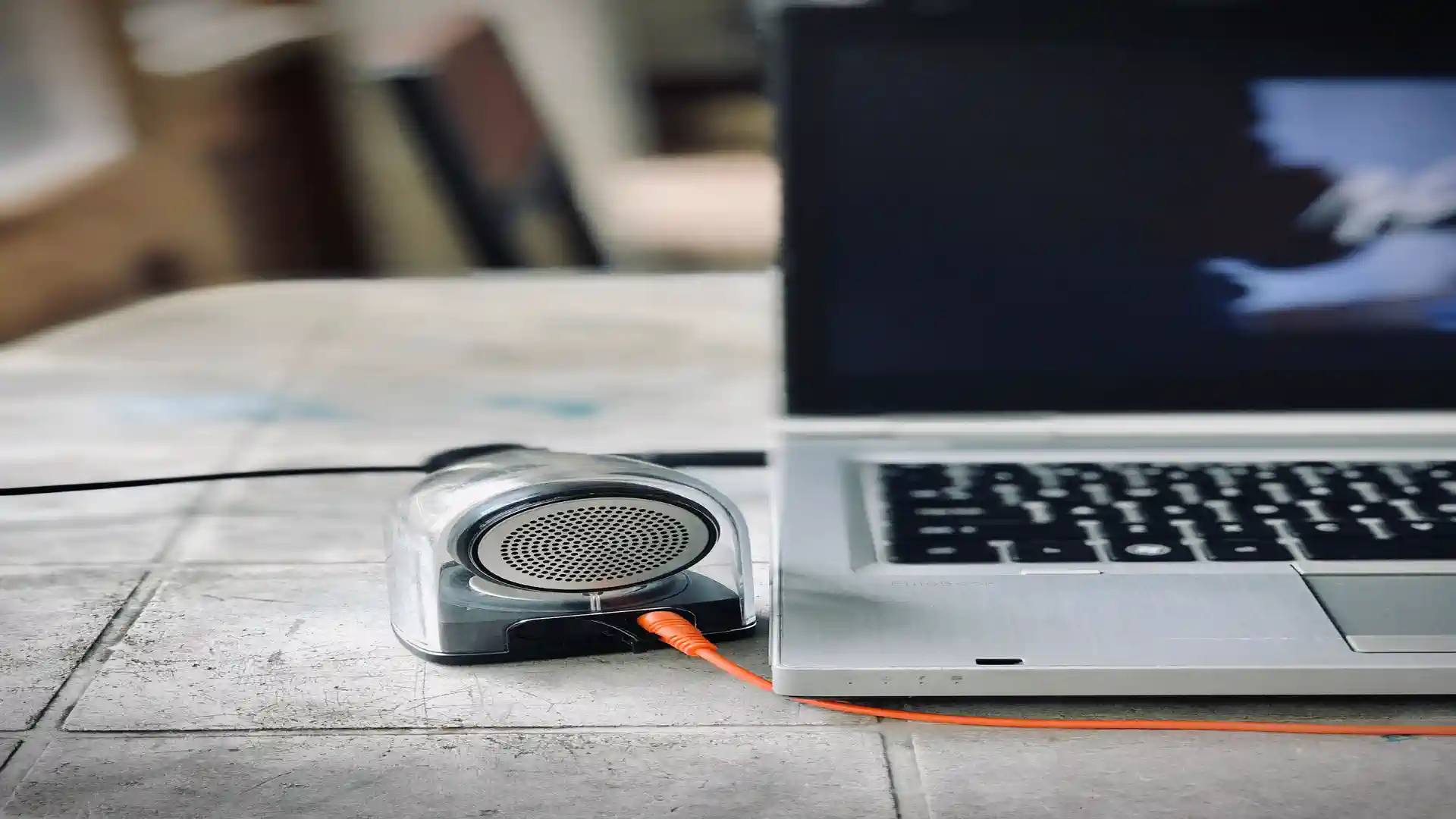 AI text to speech tools — real photo of a small speaker connected to a laptop
