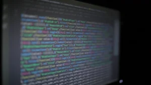 AI code review tools — real photo of colorful programming code on a dark screen