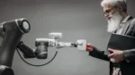 Agentic AI foundation — real photo of a robot arm handing a cup to a man in a suit