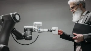 Agentic AI foundation — real photo of a robot arm handing a cup to a man in a suit